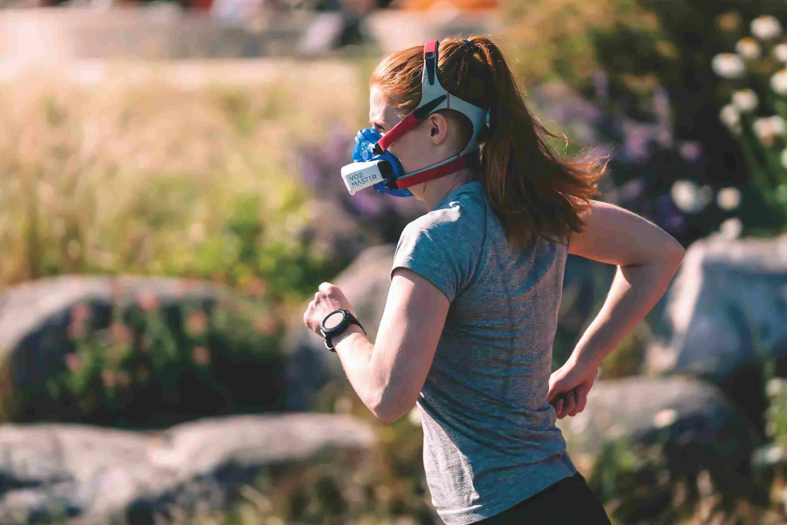 A woman running with VO2 master analyzer representing what is a good VO2 max by age.