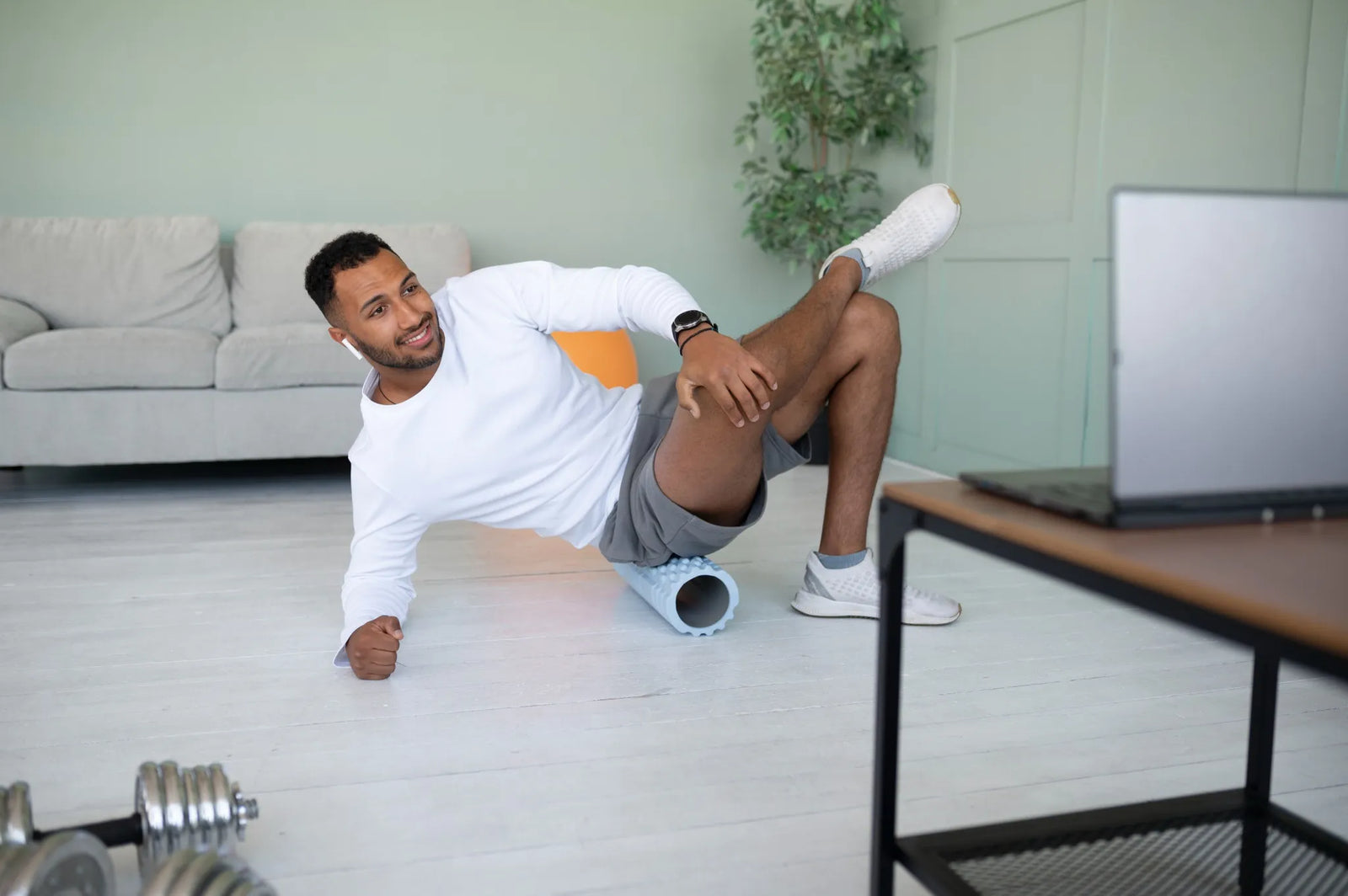 Man using a foam roller for muscle recovery at home, highlighting the benefits of using a foam roller for recovery.